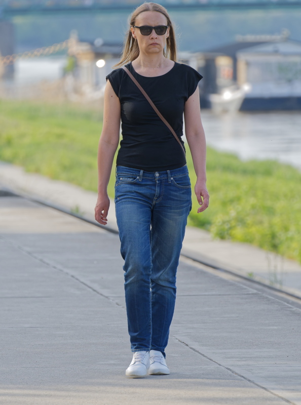 Young woman walking down an alley